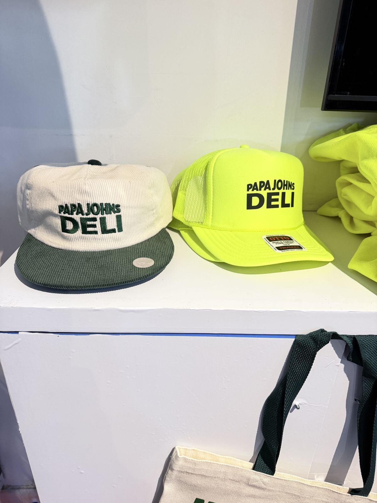 Corduroy trucker hats lined up in party colors at a hat bar