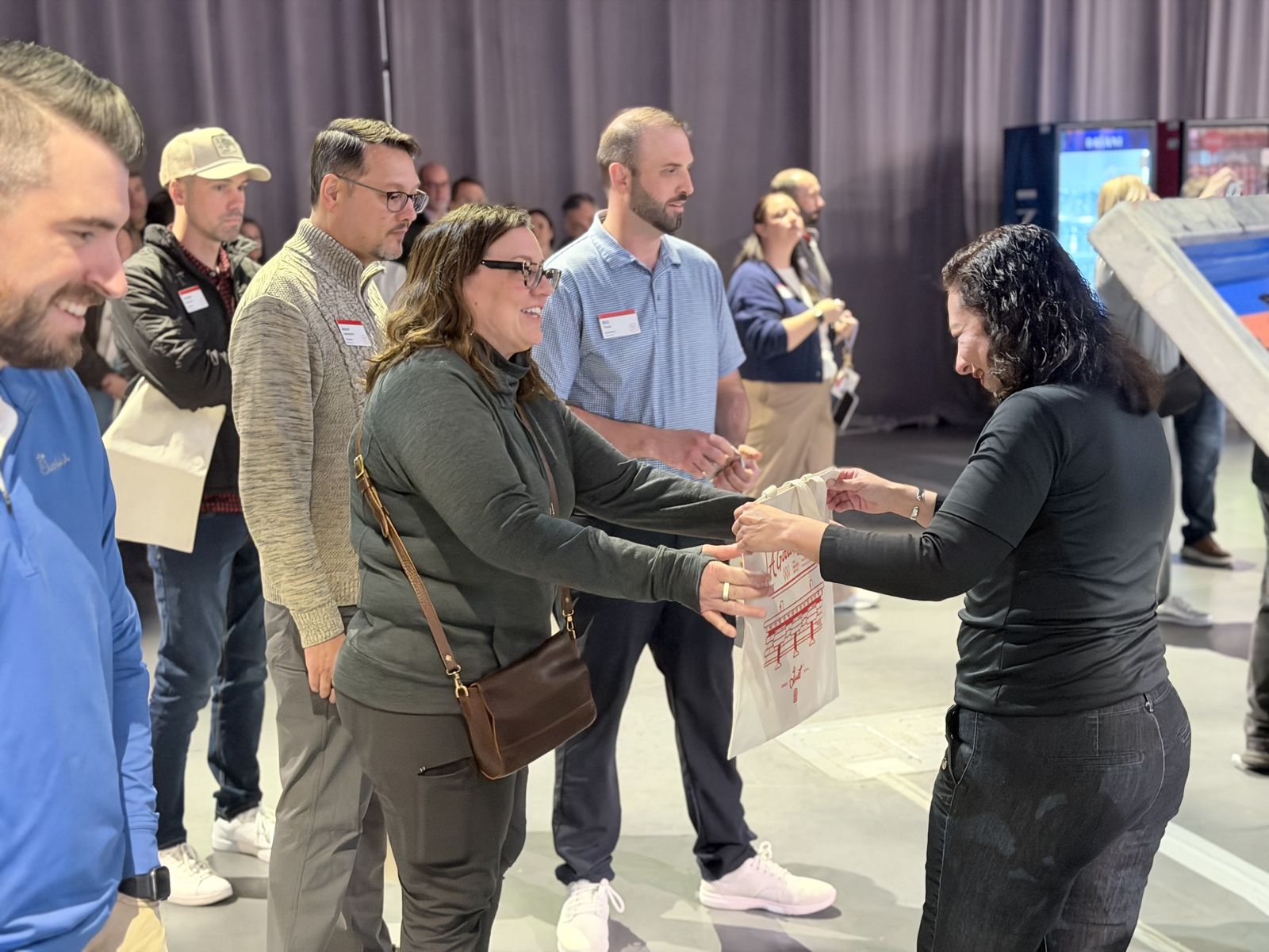 Guest picking up a freshly pressed custom hat at a party