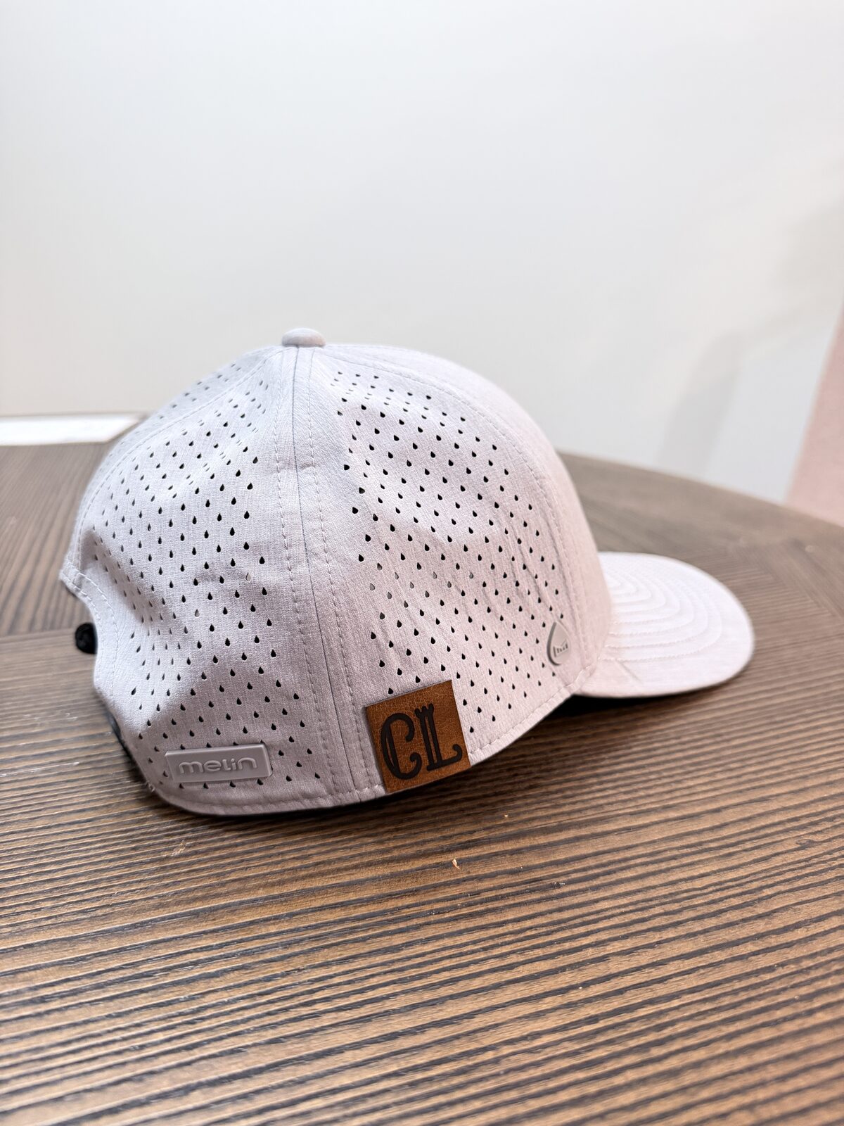 Finished cap with a pressed leather patch made at a party hat bar