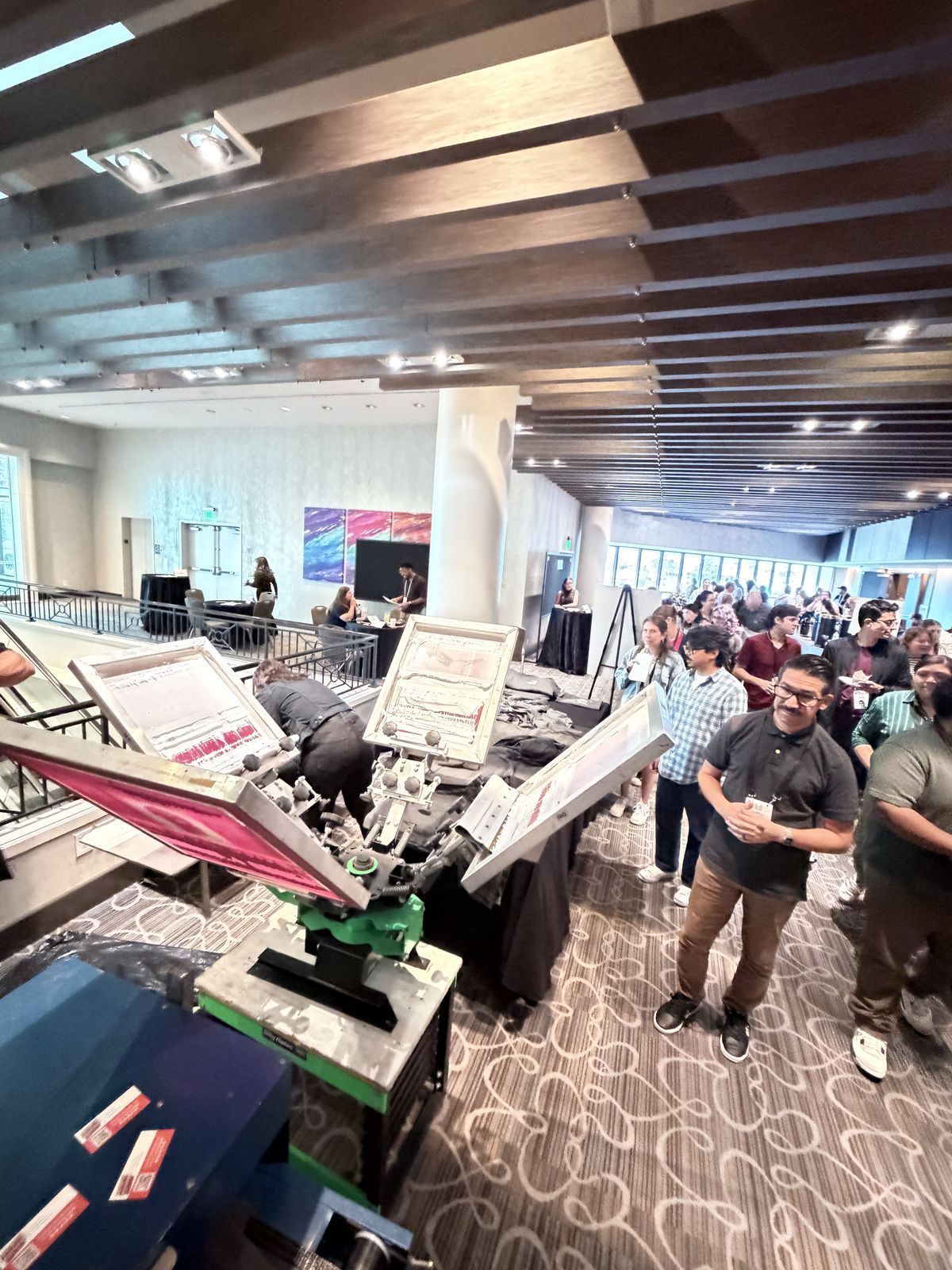 Guests lined up at a live printing station during a party